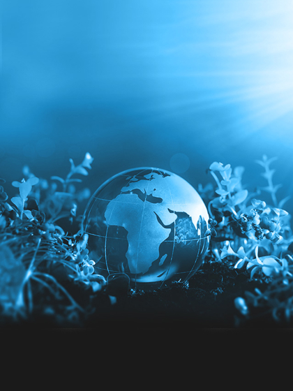 Transparent globe with a focus on Africa and Europe, placed on soil among small plants, symbolizing sustainability and environmental care.